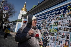 A woman near the Wall of Remembrance of those who died for Ukraine