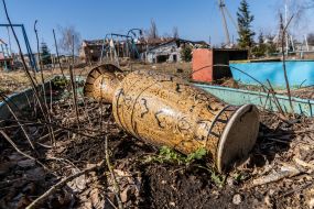 The vase is lying on the ground
