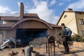 Local resident near his house in the village of Tsirkuny, Kharkiv region