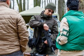 A soldier demonstrates samples of small arms