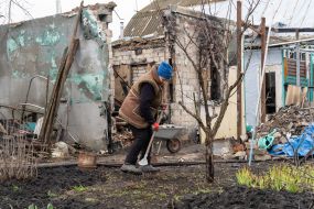 Local woman near the destroyed house in the village of Russian Tishki, Kharkov region