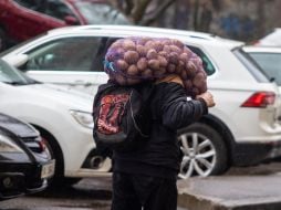 A man carries a bag of potatoes