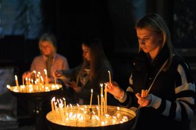 A woman puts a candle