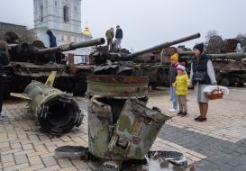 People with Easter baskets near destroyed Russian military equipment on Mykhailivska Square