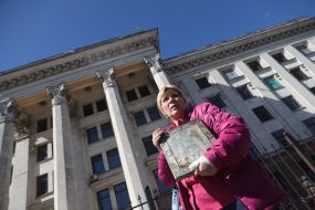 A woman with an icon near the House of Trade Unions