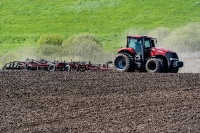 A tractor plows a field
