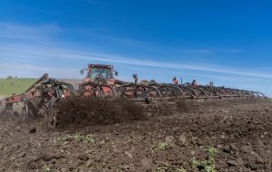 A tractor plows a field