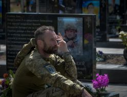 Soldiers near the graves of the fallen defenders of Ukraine