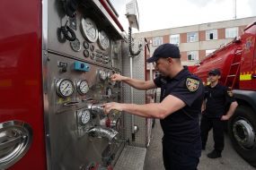 A rescuer examines an American fire truck