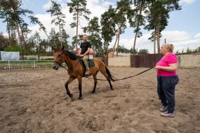 A soldier of the Ukrainian army rides a horse during a session of hippotherapy