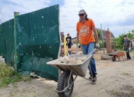 Volunteers dismantle a destroyed house in the village of Moschun, Kyiv region