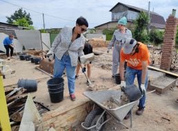 Volunteers dismantle a destroyed house in the village of Moschun, Kyiv region