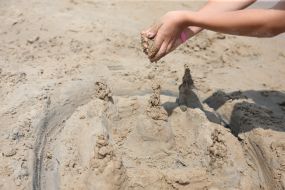 Children build a sandcastle