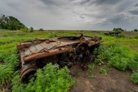 Wreck of a blown up tank in a field in the Kharkiv region