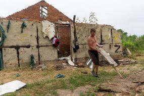 Local resident Valery Khmil is repairing his destroyed house in the Kharkiv region