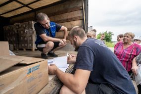 Volunteers distribute humanitarian aid to local residents in the Kharkiv region