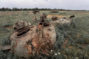 Towers of blown-up tanks lie in a field in the Kharkiv region