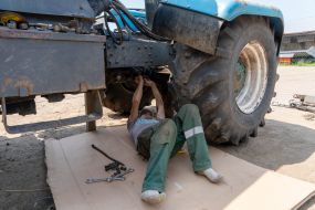 Machine operators repair agricultural machinery