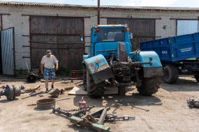 Machine operators repair agricultural machinery