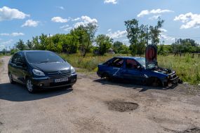 The car passes by a damaged car