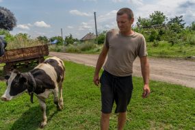 Local resident Ruslan Rudnev with his cow