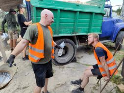 Ukrainian and foreign volunteers are sorting through the rubble of private houses destroyed by the Russian occupiers in the village of Horenka