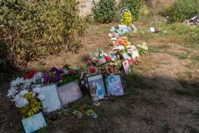 An impromptu memorial to the memory of the dead residents near a house destroyed by an aerial bomb