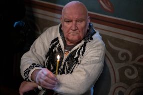 A man holds a candle