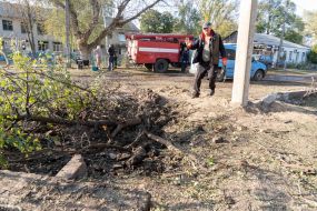 Local residents near a ravine near a house damaged by an aerial bomb explosion