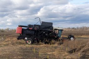 A mine-struck combine harvester in an agricultural field