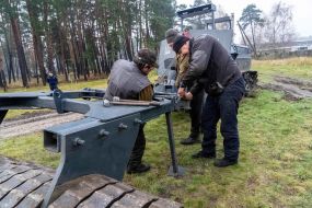 Specialists from the engineering development team attach a mine trawl to the MP3101 mine clearing machine