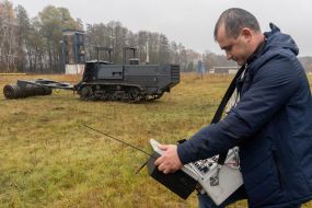 The operator of the MP3101 demining machine holds the remote control