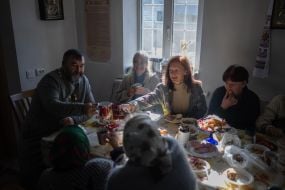 A priest and parishioners are having lunch at a table in a church building (Ostriv district) in Kherson