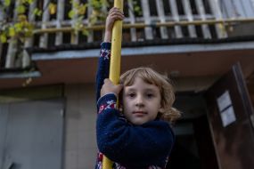 Girl on the street near a residential building in the Ostriv district of Kherson