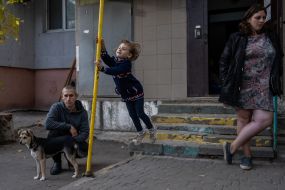 People on the street near a residential building in the Ostriv district in Kherson