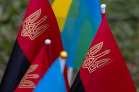 Red and black flags with the coat of arms of Ukraine