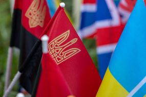 Red and black flags with the coat of arms of Ukraine