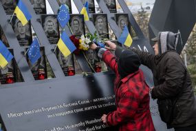 On the Day of Dignity and Freedom, people with flowers honored the memory of activists who died during the Revolution of Dignity