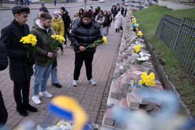 On the Day of Dignity and Freedom, people with flowers honored the memory of activists who died during the Revolution of Dignity