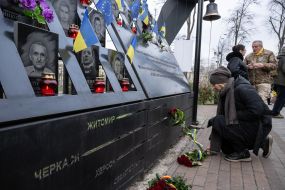 On the Day of Dignity and Freedom, people with flowers honored the memory of activists who died during the Revolution of Dignity
