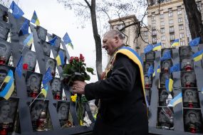 On the Day of Dignity and Freedom, a man honors the memory of activists who died during the Revolution of Dignity