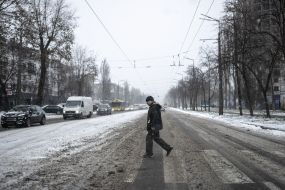 A man crosses the road in Kyiv