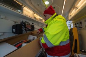 Driver examines the equipment of an ambulance