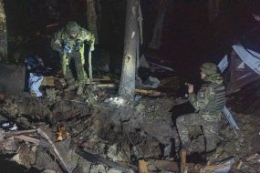 Experts inspect the crash site of a Russian missile