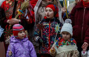 Participants of the procession of stars sing carols