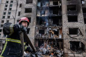 Rescuers near a residential building in Kyiv destroyed by Russian rocket fire
