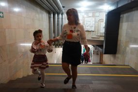A teacher with a girl in an underground kindergarten in the Kharkiv metro