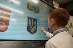 Boy near an interactive board in an underground kindergarten in the Kharkiv metro
