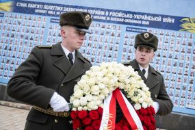 Laying flowers at the memorial wall of those who died in the Russian-Ukrainian war