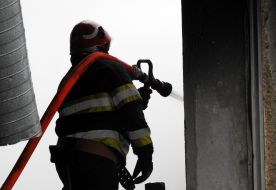 A rescuer puts out a fire at a service station